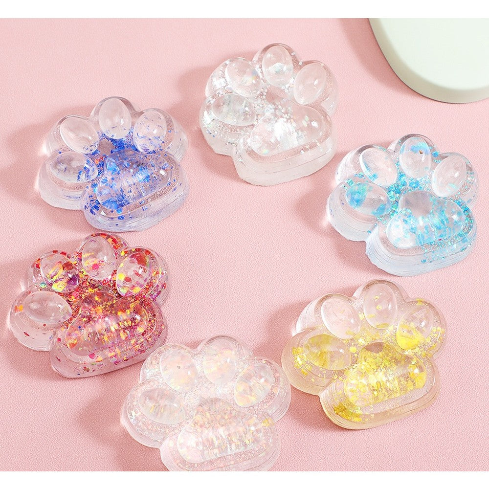 Jucarie Antistres Squishy, Klevo, cu Revenire Lenta, Squeeze Pinch Family, Model Cat Paw, 6.5 x 7 cm, din Tpr, 4-6 Ani, Model 4 Sclipici, Transparent