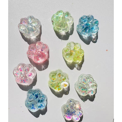 Jucarie Antistres Squishy, Klevo, cu Revenire Lenta, Squeeze Pinch Family, Model Cat Paw, 6.5 x 7 cm, din Tpr, 4-6 Ani, Model 4 Sclipici, Transparent