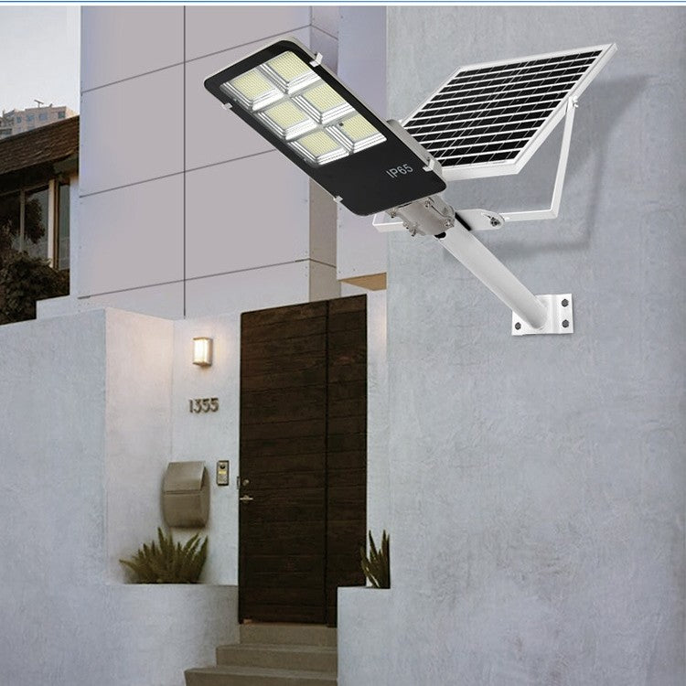 Lampa solara stradala Klevo, IP65, senzor de lumina, 100 LED-uri SMD, 7200 lm, panou 12W, putere 80W, autonomie 12-16 ore, telecomanda, montare prin fixare, pentru strada sau gradina, finisaj lucios, material ABS, 38.6 x 13.3 x 6.5 cm, lumina alb rece